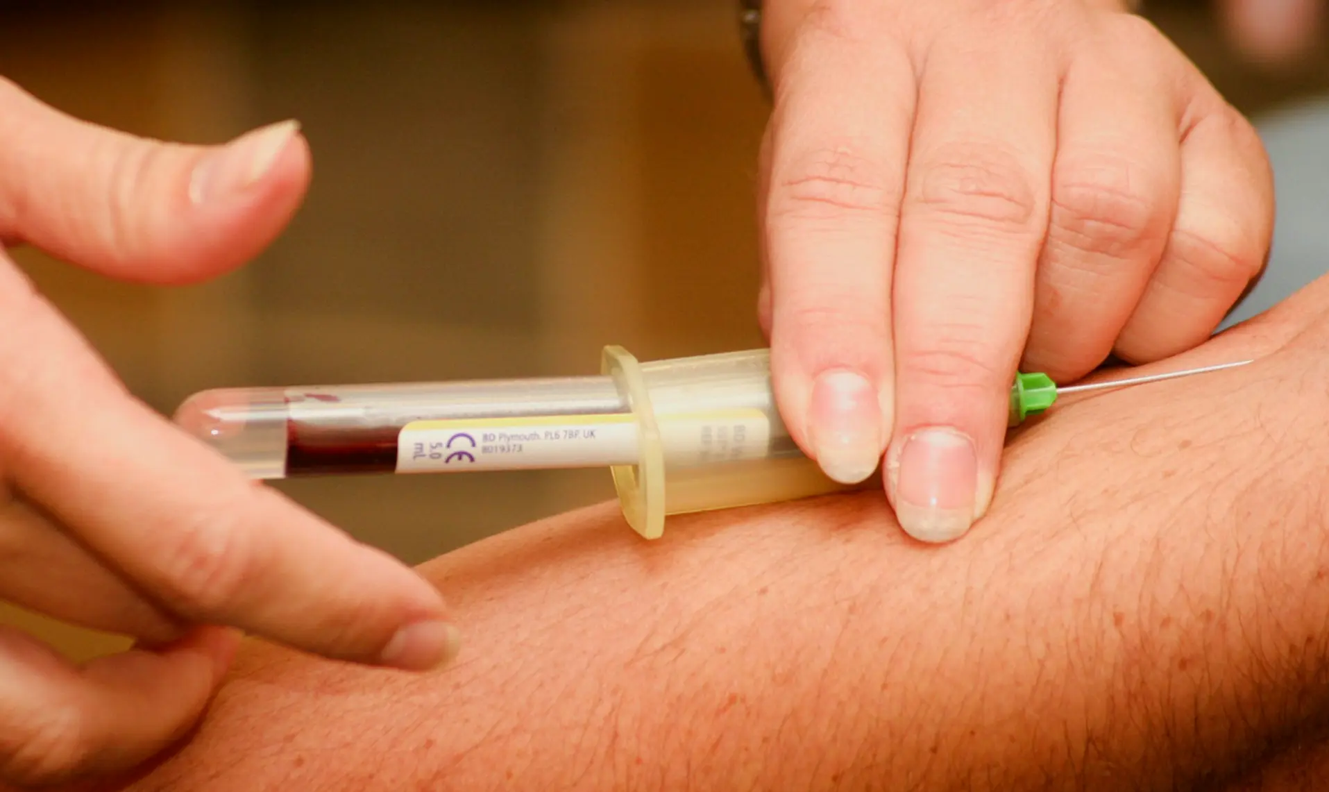 person injecting syringe